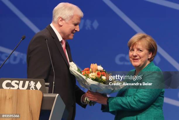 German Chancellor and leader of the German Christian Democrats Angela Merkel receives flowers by Horst Seehofer , Governor of Bavaria and leader of...