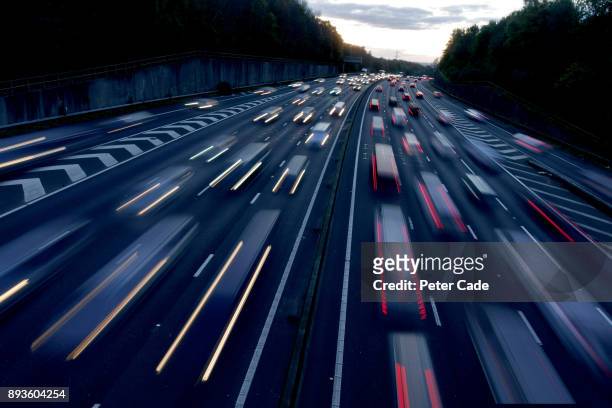 busy road at dusk - traffic stock pictures, royalty-free photos & images