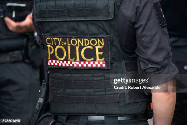 City of London Police Department officer stands at the entrance to an underground station in London, England.