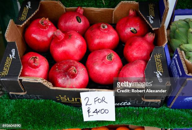Box of pomegranates for sale at a produce market in London, England.