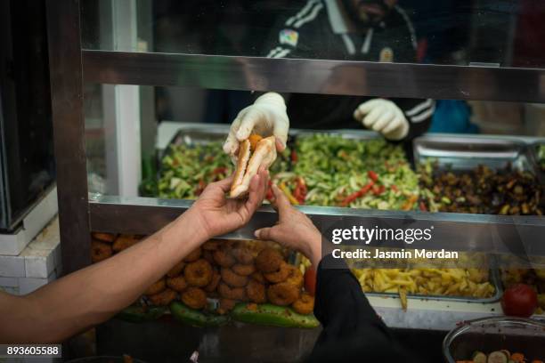 making traditional free street food distributed to people - falafel stock pictures, royalty-free photos & images