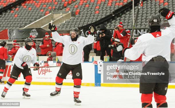 Nate Thompson of the Ottawa Senators celebrates a goal with teammates Tom Pyatt and Gabriel Dumont during practice at Lansdowne Park on December 15,...