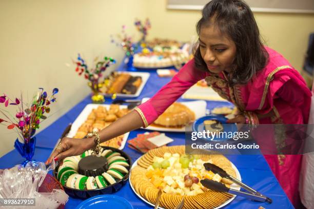 Popi grabs utensils for her food during a party thrown for her at Toronto General Hospital. In September in her hometown in Bangladesh, Popi Rani Das...