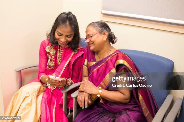 Popi and her mother, Anjata Das, look at photos on Popi's phone during a party thrown for her at Toronto General Hospital. In September in her...