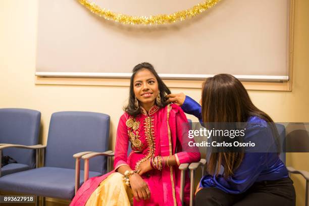 Popi has her hair adjusted by her social worker Shobha Sawh during a party thrown for Popi at Toronto General Hospital. In September in her hometown...