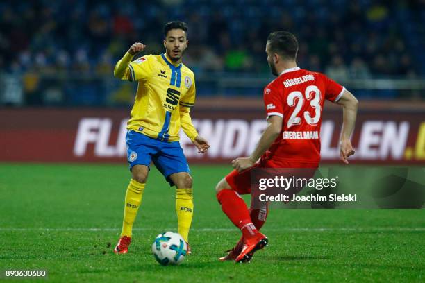 Salim Khelifi of Braunschweig challenges Niko Giesselmann of Duesseldorf during the Second Bundesliga match between Eintracht Braunschweig and...