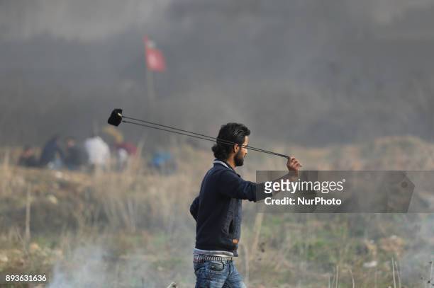Palestinian protesters hurl stones towards Israeli troops during clashes following a protest against US President Donald Trump's decision to...