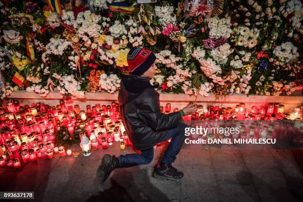 People light candles for the late King Michael I of Romania in front of the former Royal Palace that houses the National Arts Museum, where the...