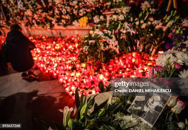 People light candles for the late King Michael I of Romania in front of the former Royal Palace that houses the National Arts Museum, where the...