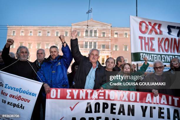 Greek pensioners react during a demonstration in front of the Greek parliament in Athens on December 15, 2017. Pensioners' associations from all...