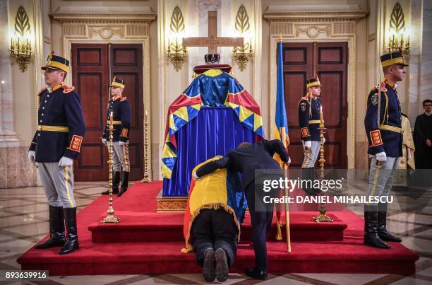 Man dressed with Romanian flag pays his respects to the late King Michael I of Romania inside the former Royal Palace that houses the National Arts...