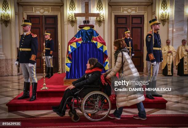People pay their respects to the late King Michael I of Romania inside the former Royal Palace that houses the National Arts Museum, where the coffin...