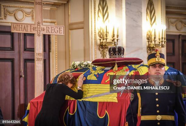 The crown custodian Princess Margaret, daughter of King Michael of Romania leans on the King's coffin inside the former Royal Palace that houses the...