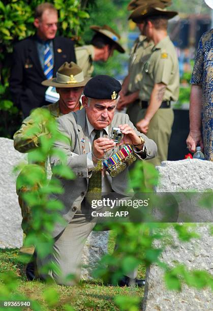 Asia-WWII-history-cemeteries BY ROMEN BOSE A picture dated June 11, 2009 shows an unidentified veteren Australian soldier taking pictures of the...