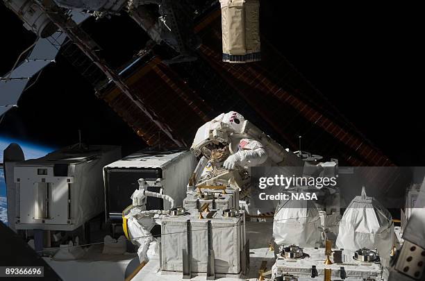 In this photo provided by NASA, Astronaut Christopher Cassidy, STS-127 mission specialist, handles the Japanese Experiment Module - Exposed Facility,...