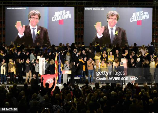 Junts per Catalonia' - JUNTSXCAT grouping candidates for the upcoming Catalan regional election, applaud on stage as main candidate Carles Puigdemont...