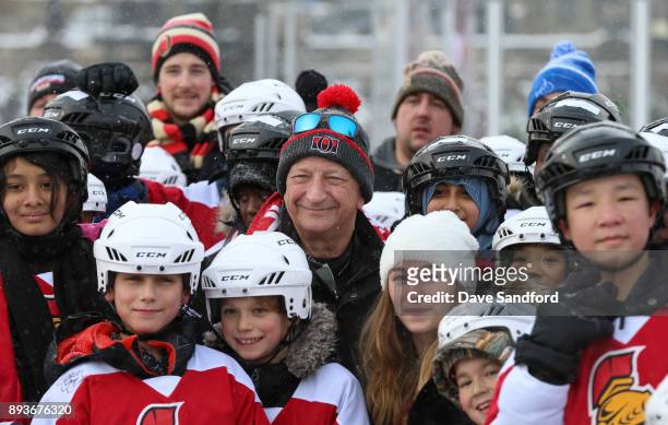 Eugene Melnyk poses for a photo with skaters during the 2017 Scotiabank NHL100 Classic Eugene Melnyk Skate for kids on Parliament Hill on December...
