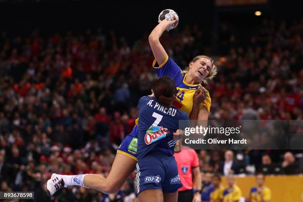 Allison Pineau of France and Johanna Westberg of Sweden challenges for the ball during the IHF Women's Handball World Championship Semi Final match...