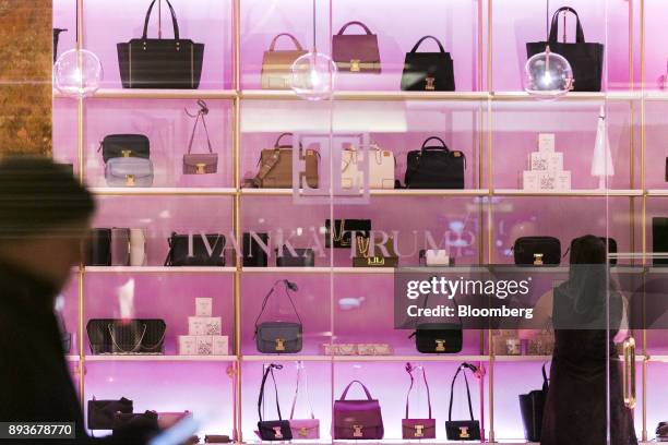 An employee arranges handbags on display inside an Ivanka Trump brand store at Trump Tower in New York, U.S., on Thursday, Dec. 14, 2017. Trump's new...