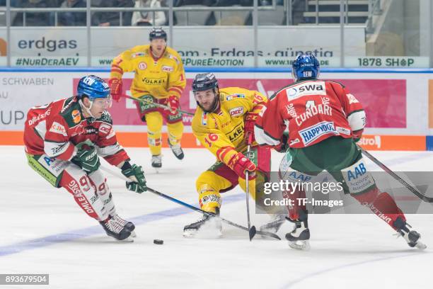 Simon Sezemsky of Augsburger Panther, John Henrion of Duesseldorfer EG and Mark Cundari of Augsburger Panther battle for the ball during the DEL...