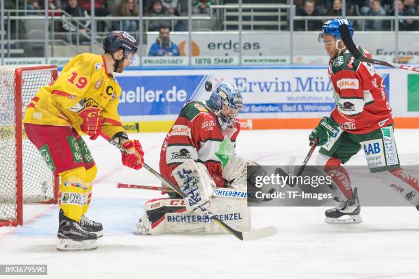 Darryl Boyce of Duesseldorfer EG, Olivier Roy of Augsburger Panther and Mark Cundari of Augsburger Panther battle for the ball during the DEL match...