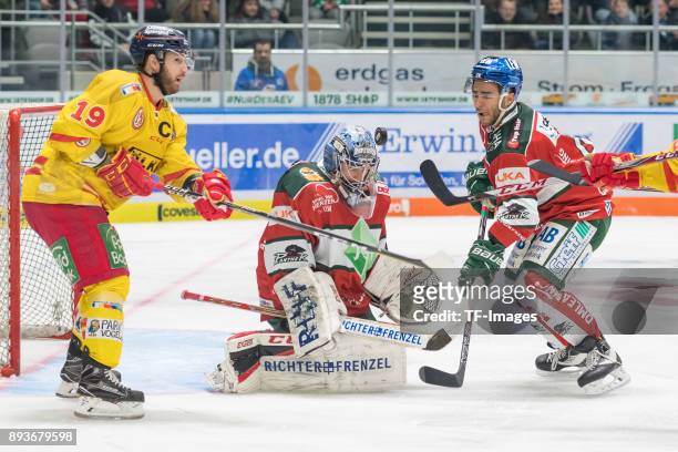 Darryl Boyce of Duesseldorfer EG, Olivier Roy of Augsburger Panther and Mark Cundari of Augsburger Panther battle for the ball during the DEL match...