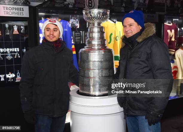 Fans pose with the Stanley Cup in the Centennial Fan Arena on Parliament Hill in advance of the 2017 Scotiabank NHL100 Classic on December 15, 2017...