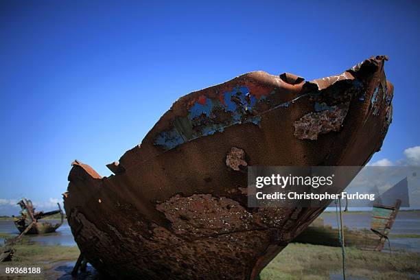 The rotting hulks of old boats decay in the sands of Fleetwood Marshes on July 27, 2009 in Fleetwood, England. Seven boats have been rusting and...