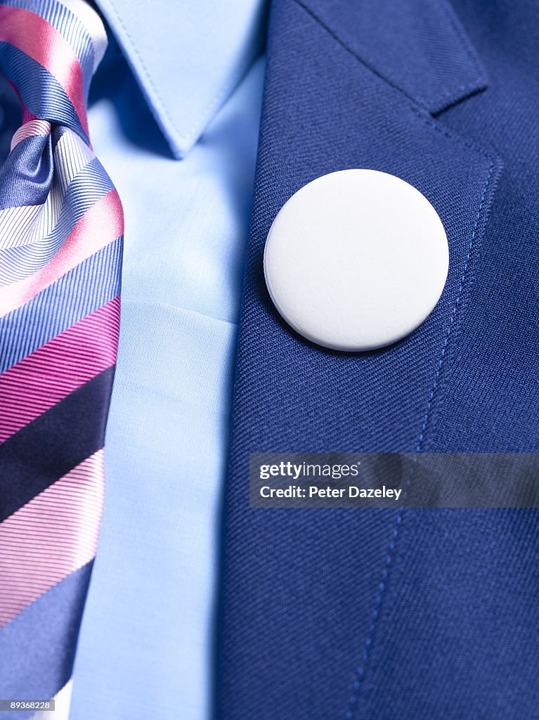 Blank button badge on lapel.