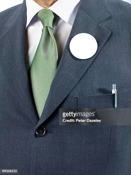 man in suit with blank button badge. - circle badge stock pictures, royalty-free photos & images