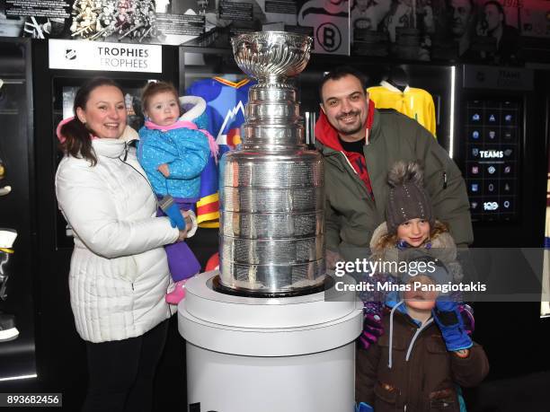 Fans pose with the Stanley Cup in the Centennial Fan Arena on Parliament Hill in advance of the 2017 Scotiabank NHL100 Classic on December 15, 2017...