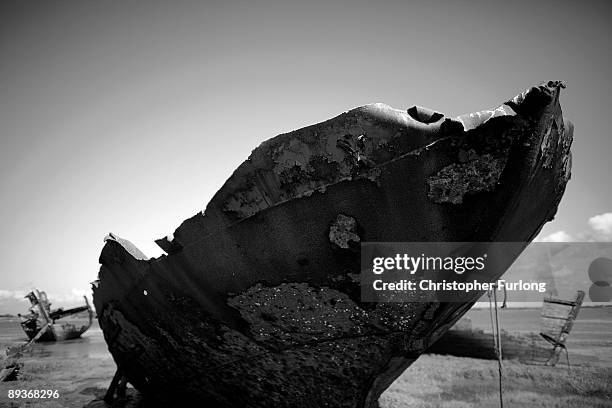 The rotting hulks of old boats decay in the sands of Fleetwood Marshes on July 27, 2009 in Fleetwood, England. Seven boats have been rusting and...