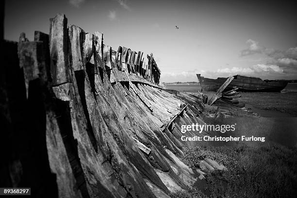 The rotting hulks of old boats decay in the sands of Fleetwood Marshes on July 27, 2009 in Fleetwood, England. Seven boats have been rusting and...