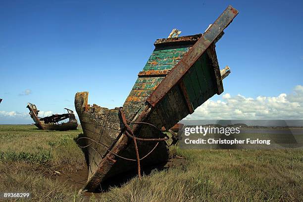 The rotting hulks of old boats decay in the sands of Fleetwood Marshes on July 27, 2009 in Fleetwood, England. Seven boats have been rusting and...