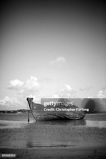 The rotting hulks of old boats decay in the sands of Fleetwood Marshes on July 27, 2009 in Fleetwood, England. Seven boats have been rusting and...