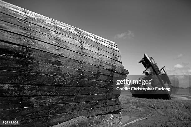 The rotting hulks of old boats decay in the sands of Fleetwood Marshes on July 27, 2009 in Fleetwood, England. Seven boats have been rusting and...