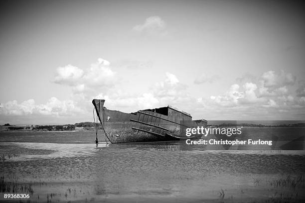 The rotting hulks of old boats decay in the sands of Fleetwood Marshes on July 27, 2009 in Fleetwood, England. Seven boats have been rusting and...