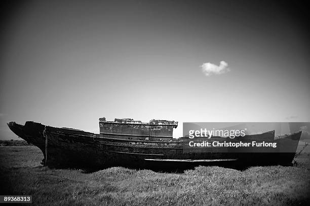 The rotting hulks of old boats decay in the sands of Fleetwood Marshes on July 27, 2009 in Fleetwood, England. Seven boats have been rusting and...