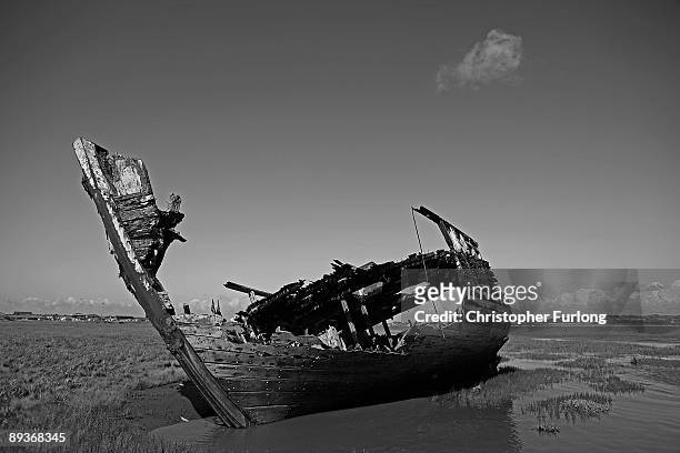 The rotting hulks of old boats decay in the sands of Fleetwood Marshes on July 27, 2009 in Fleetwood, England. Seven boats have been rusting and...