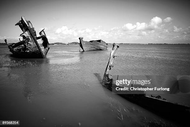 The rotting hulks of old boats decay in the sands of Fleetwood Marshes on July 27, 2009 in Fleetwood, England. Seven boats have been rusting and...