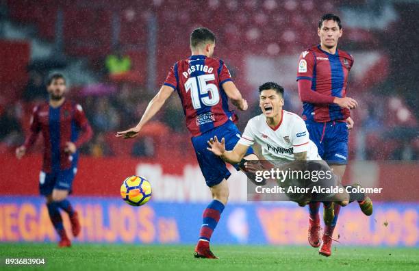 Joaquin Correa of Sevilla duels for the ball with Sergio Postigo of Levante during the La Liga match between Sevilla and Levante at Estadio Ramon...