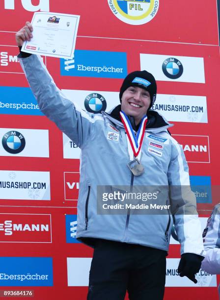 Tucker West of the United States celebrates after winning the bronze medal in the Men's competition of the Viessmann FIL Luge World Cup at Lake...