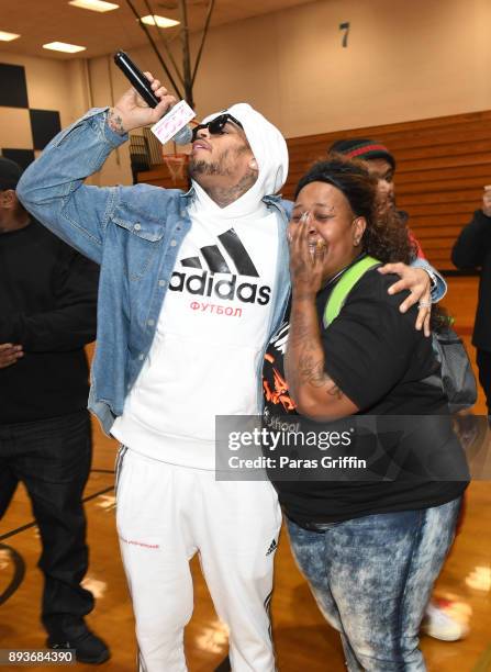 Singer Chris Brown surprises school teacher Tracie Reeves with a donation of $50,000 to her school at V-103 Atlanta Winterfest pop-up at Columbia...