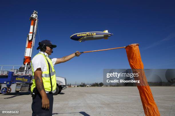 Ground crew member checks the wind as the Goodyear Tire & Rubber Co. Wingfoot Two blimp arrives at the company's airship base in Carson, California,...