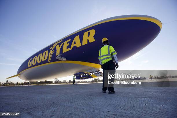 Ground crew members guide the Goodyear Tire & Rubber Co. Wingfoot Two blimp as it arrives at the company's airship base in Carson, California, U.S.,...