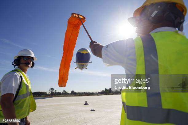 Ground crew members guide the Goodyear Tire & Rubber Co. Wingfoot Two blimp as it arrives at the company's airship base in Carson, California, U.S.,...