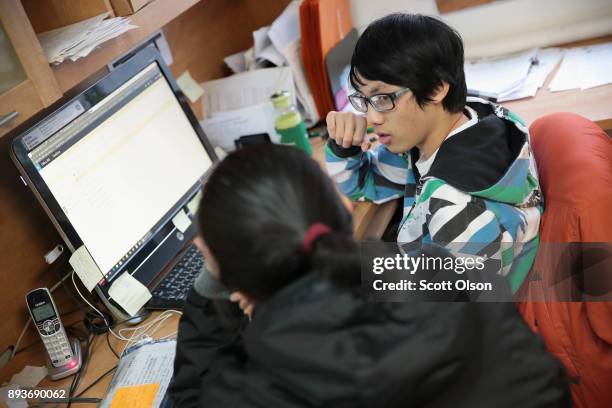 Justin Huang helps a client sign up for a health insurance program under the Affordable Care Act , also known as Obamacare, at the offices of the...