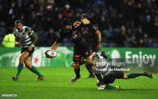 Lewis Carmichael of Edinburgh is tackled by Andrei Garbuzov of Krasny Yar during the European Rugby Challenge Cup match between Edinburgh and Krasny...