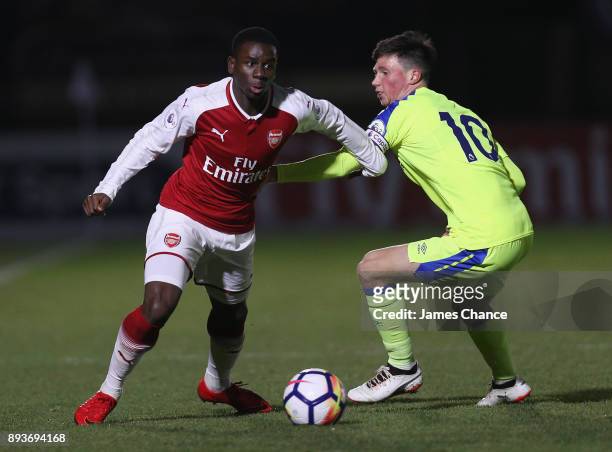 Jordi Osei Tutu of Arsenal takes the ball past Charles Vernam of Derby during the Premier League 2 match between Arsenal and Derby County at Meadow...
