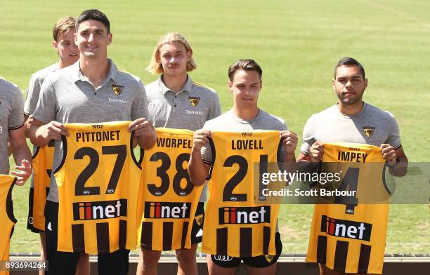 Marc Pittonet, James Worpel, Kieran Lovell and Jarman Impey of the Hawks hold their new guernsey numbers at the jumper number reveal during a...